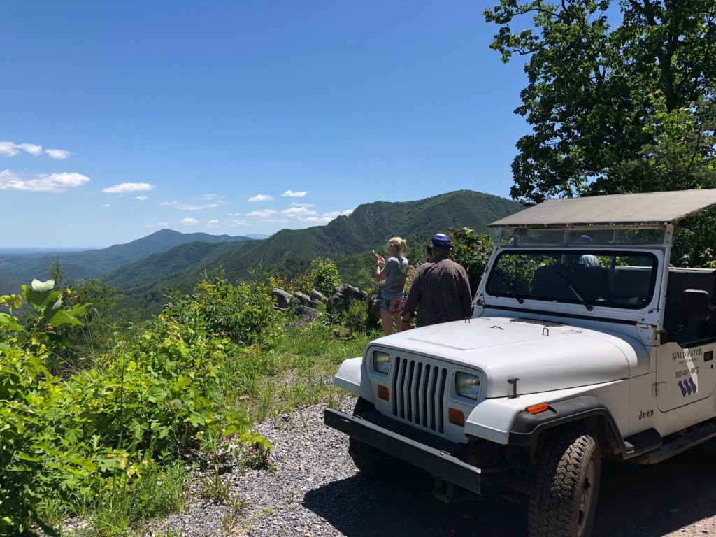 Jeep overlooking mountains on gravel road