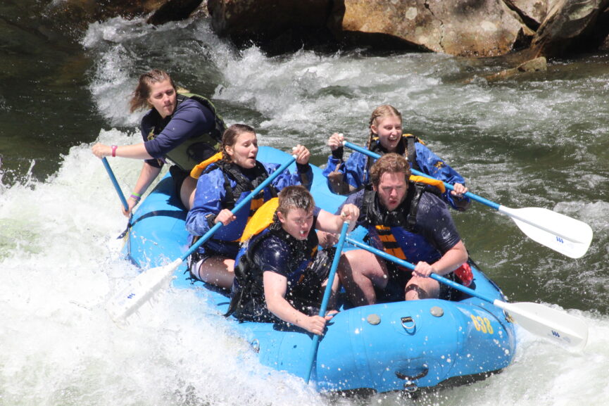 A group of people in a raft on the Nantahala River