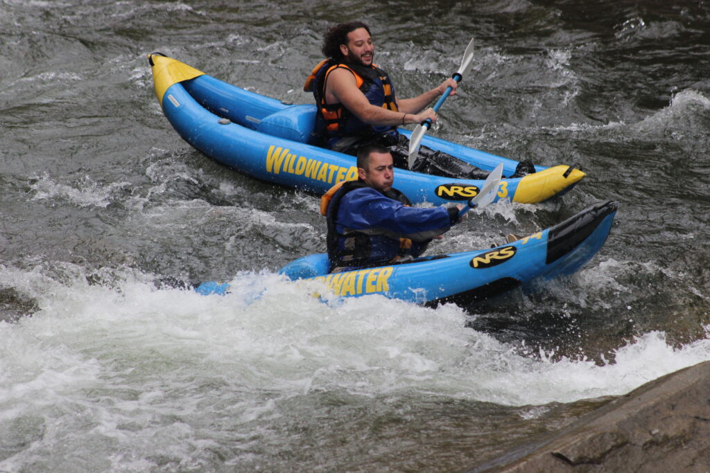 Two men paddling in two inflatable kayaks on the Nantahala River