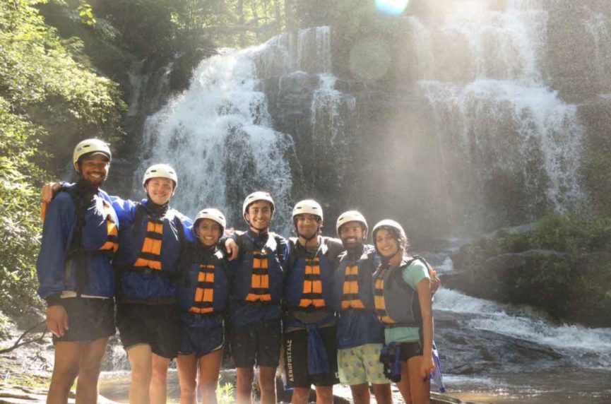 group in front of waterfall